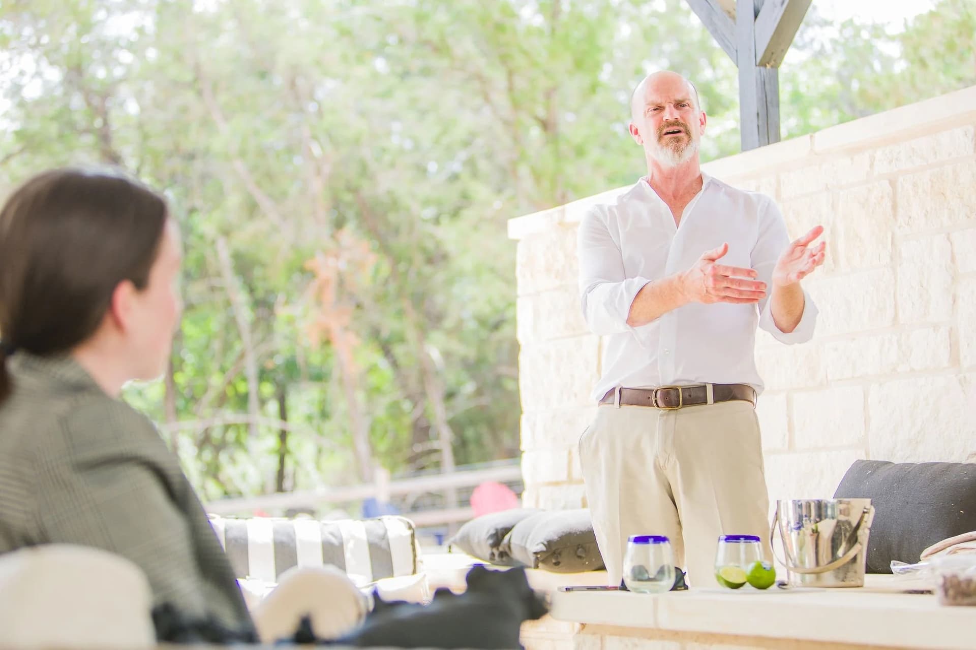 Business owner photographed in their actual workspace environment, showing their team the next product launch, an environmental portrait showing them naturally in context with their brand