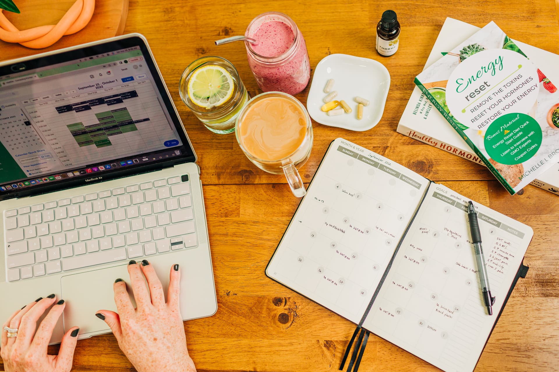 Entrepreneur in a behind-the-scenes lifestyle portrait, working naturally at their desk with soft window light and authentic brand elements visible