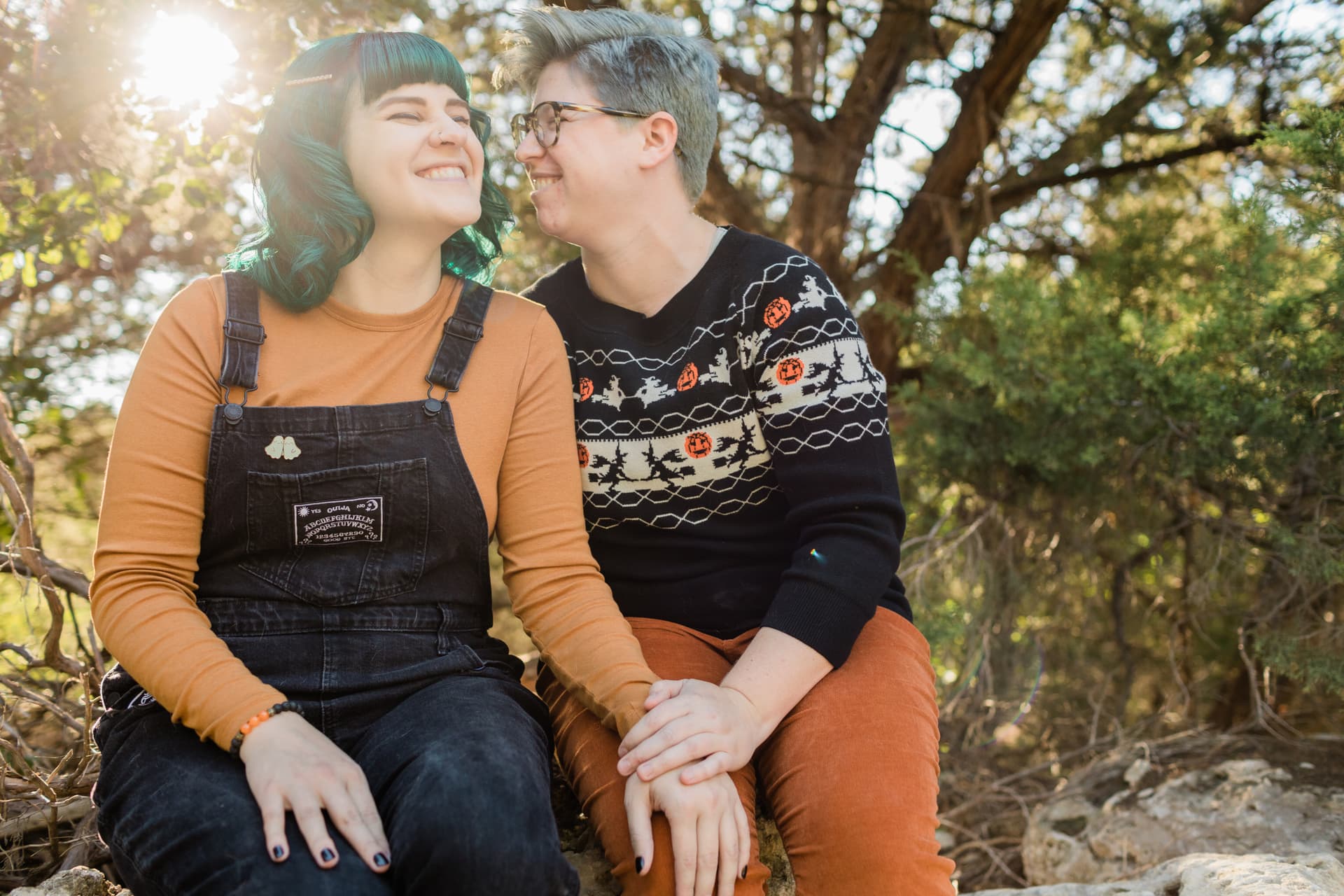 Couple standing on a tree-lined walking path at Walnut Creek Park with green canopy overhead and soft filtered light